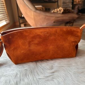 KHAITE Alma wristlet clutch in Cognac
